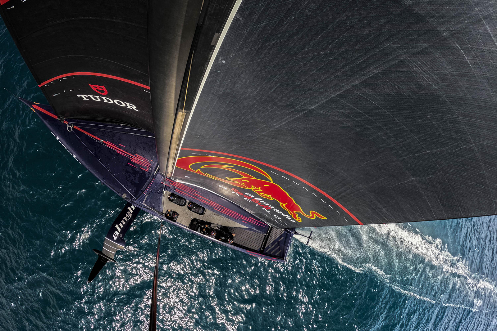 A sailing team moving across open water